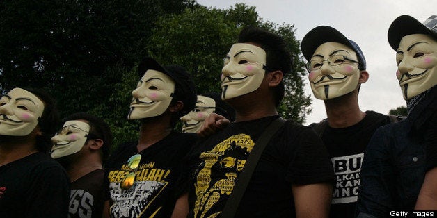 KUALA LUMPUR, MALAYSIA - MAY 25: :Political activists wear anonymous masks during a political rally against election fraud on May 25, 2013 in Kuala Lumpur, Malaysia. Thousands of supporters of Pakatan Rakyat (People's Pact/People's Alliance) gathered to voice their dissatisfaction over alleged election fraud in Malaysia's 13th General election result. (Photo by Rahman Roslan/Getty Images)