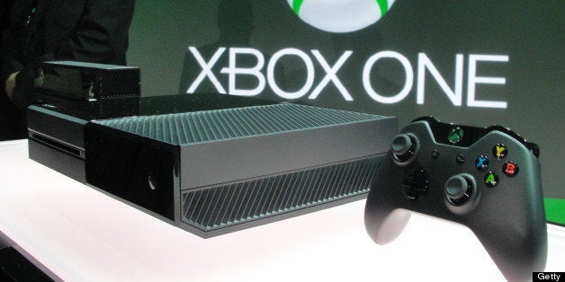 A member of the Microsoft security team watches over the newly unveiled Xbox One videogame console at the Microsoft campus in