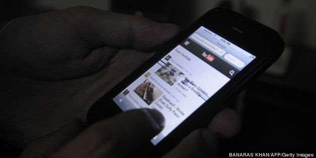 A Pakistani cell phone user browses YouTube on his mobile phone in Quetta on December 29, 2012. Pakistan briefly unblocked access to the popular video sharing website YouTube before Prime Minister Raja Pervez Ashraf ordered the plug be pulled again. AFP PHOTO/Banaras KHAN (Photo credit should read BANARAS KHAN/AFP/Getty Images)