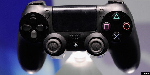 LOS ANGELES, CA - JUNE 11: A Playstation 4 and its controller is on display at the Sony Playstation E3 2013 booth at the Los