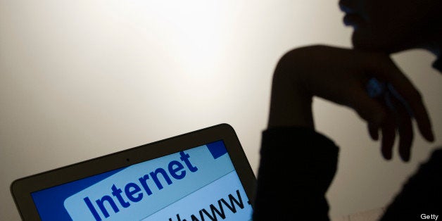 A woman looks at a webpage while connecting on the internet on March 15, 2013 in Paris. AFP PHOTO / LIONEL BONAVENTURE (Photo credit should read LIONEL BONAVENTURE/AFP/Getty Images)