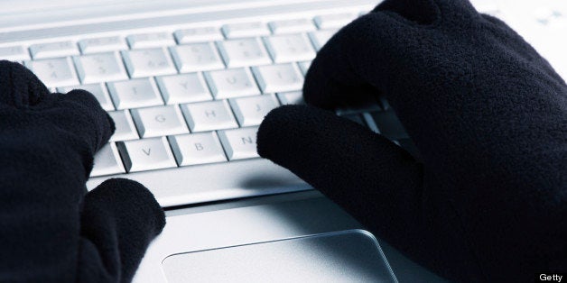 IT Crime consept Hacker works on laptop