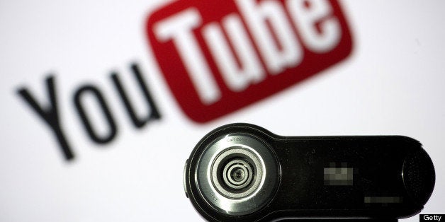 TO GO WITH AFP STORY BY NATHALIE ALONSO A webcam is positioned in front of YouTube's logo on June 28, 2013 in Paris. A new t