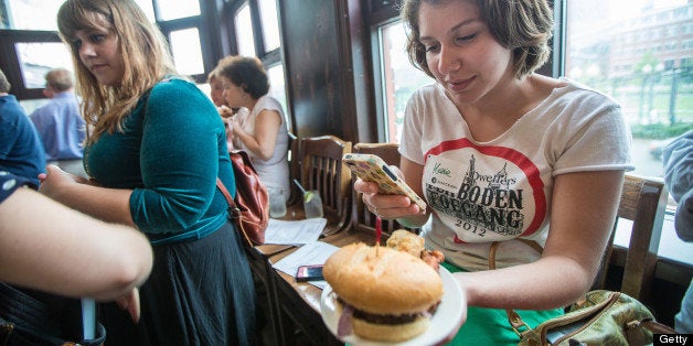 BOSTON - JULY 10: Participant Kassie Porcaro, 20, of Boston, took an Instagram of her plate at Goody Glover's in Boston during a Dishcrawl. Twenty two participants went to four different North End restaurants. (Photo by Aram Boghosian for The Boston Globe via Getty Images)