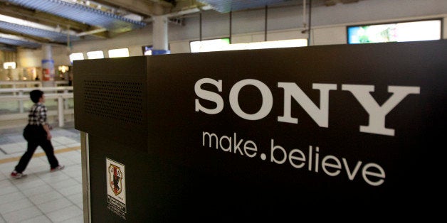 A man walks near the Sony Corp. logo on a display of the company's products in Tokyo, Japan, on Tuesday, April 10, 2012. Sony