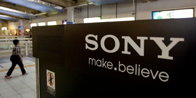 A man walks near the Sony Corp. logo on a display of the company's products in Tokyo, Japan, on Tuesday, April 10, 2012. Sony Corp., Japan's largest electronics exporter, forecast its worst annual loss since at least 1990 and said it will take a charge in the fourth quarter for taxes. Photographer:Tomohiro Ohsumi/Bloomberg via Getty Images