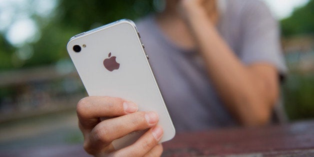 An Apple Inc. iPhone is displayed for a photograph in the Brooklyn borough of New York, U.S., on Tuesday, Aug. 27, 2013. Apple Inc. plans to roll out an iPhone trade-in program in certain stores Aug. 30 and more broadly in September, according to 9to5Mac. Photographer: Craig Warga/Bloomberg via Getty Images