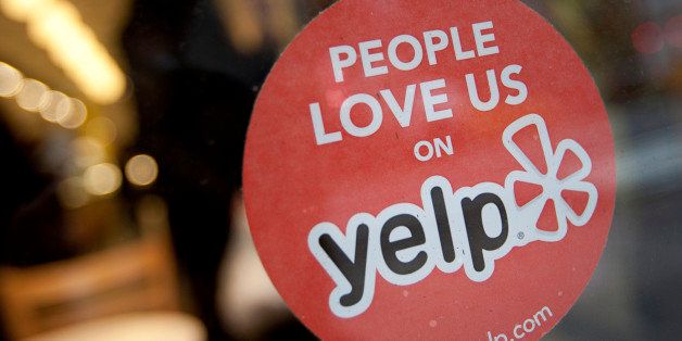 The Yelp Inc. logo is displayed in the window of a restaurant in New York, U.S., on Thursday, March 1, 2012. Yelp Inc., the site that lets users review everything from diners to dentists, is set to price it's IPO tonight and could potentially raise as much as $100 million, which would value the company at about $838 million. Photographer: Scott Eells/Bloomberg via Getty Images