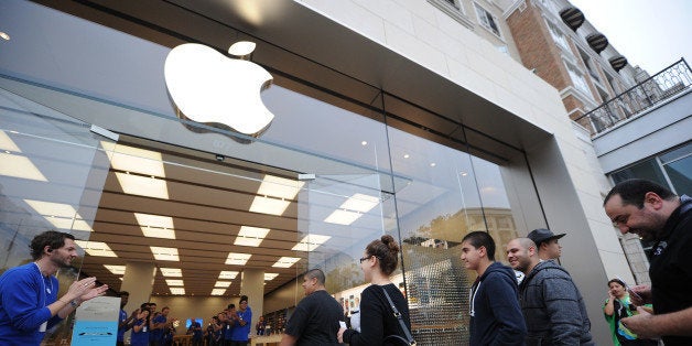 The first customers walk into the Apple Store at the Americana at Brand shopping complex in Glendale, California, September 20, 2013 to buy the new Apple iPhones. Apple launched two new models of the iPhone today - the iPhone 5S, which is an updated version of the iPhone 5, and a less expensive version, the iPhone 5C. AFP PHOTO / Robyn Beck (Photo credit should read ROBYN BECK/AFP/Getty Images)