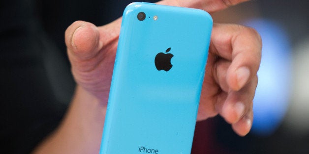 A customer views an Apple Inc. iPhone 5c displayed during the devices launch at the company's store in New York, U.S., on Fri