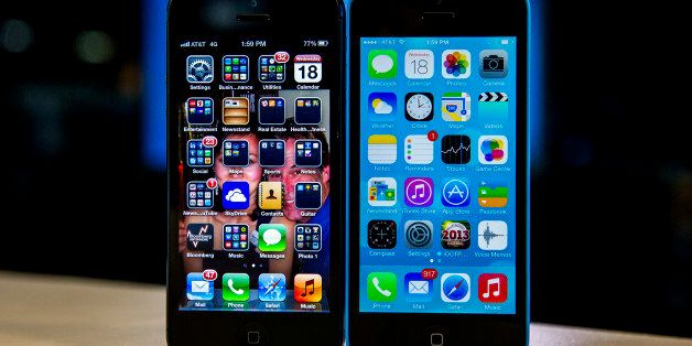 The home screen of an Apple Inc. iPhone 5 operating iOS 6, left, and an iPhone 5C operating iOS 7 is displayed in San Francisco, California, U.S., on Wednesday, Sept. 18, 2013. Buying memory to store more photos, videos and applications on a smartphone costs most consumers about $50. For Apple Inc. customers, it costs four times more than that. Photographer: David Paul Morris/Bloomberg via Getty Images
