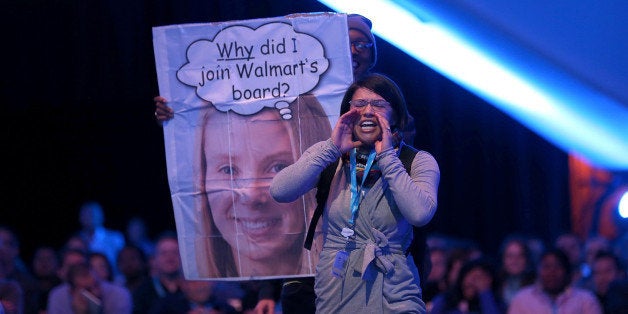 SAN FRANCISCO, CA - NOVEMBER 19: A protester shouts as Yahoo CEO Marissa Mayer speaks in conversation with Salesforce chairm