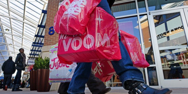 OXON HILL, MD - NOVEMBER 29: Shoppers weilding bags walk from store to store at the new Tanger Outlet Mall at National Harbor in Oxon Hill, MD on November 29, 2013. Today's post-Thanksgiving Black Friday shopping madness was in full swing at the new outlet mall that opened it's doors last week. (Photo by Linda Davidson / The Washington Post via Getty Images)