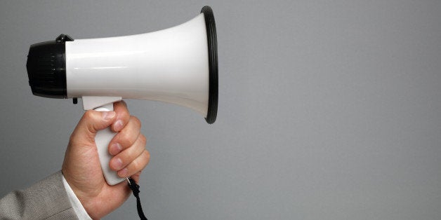 businessman holding a megaphone ...