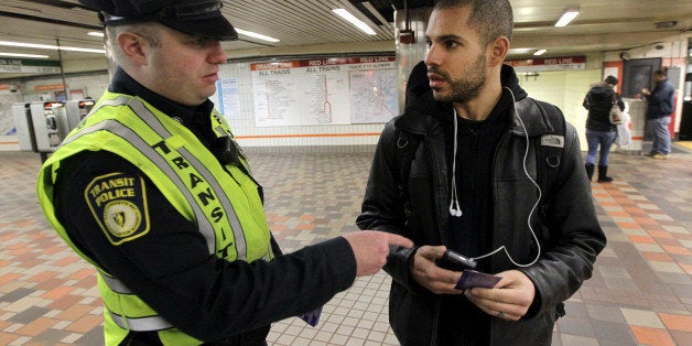 BOSTON - JANUARY 23: Transit police officer Nick Morrissey advises Luis Tejeda concerning theft of phones at the Downtown Cro