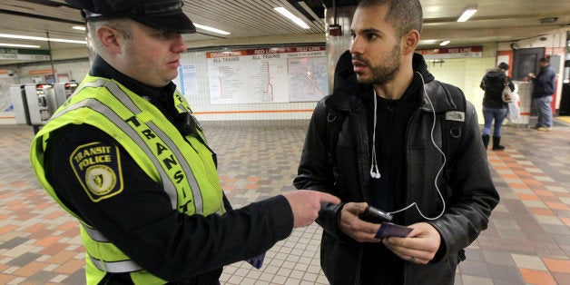 BOSTON - JANUARY 23: Transit police officer Nick Morrissey advises Luis Tejeda concerning theft of phones at the Downtown Crossing Orange line platform. (Photo by Bill Greene/The Boston Globe via Getty Images)