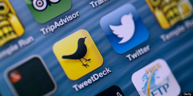Logos for Twitter Inc.'s TweetDeck app, center left, and Twitter app, center right, are seen on the screen of an Apple Inc. i