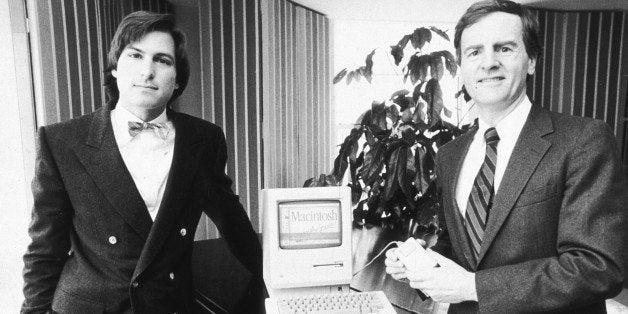 16th January 1984: American businessman Steve Jobs (L), Chairman of Apple Computers, and John Sculley, Apple's president, pose with the new Macintosh personal computer, New York City. (Photo by Marilyn K. Yee/New York Times Co./Getty Images)