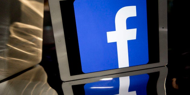 The Facebook Inc. logo is displayed on an Apple Inc. iPad Air in this arranged photograph in Washington, D.C., U.S., on Monda