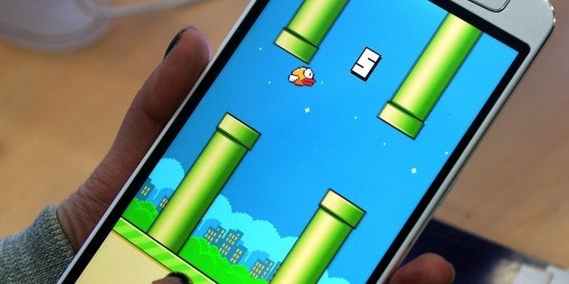 An employee plays the game Flappy Bird at a smartphone store in Hanoi on February 10, 2014. The Vietnamese developer behind