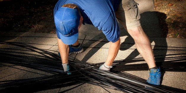 Richard Robert McKeever, a fiber install technician for US Internet Corp., adjusts fiber optic internet cable so it does not become tangled during installation in Minneapolis, Minnesota, U.S., on Thursday, Sept. 11, 2013. The US Internet Corp. gigabit residential service is symmetrical with Google Inc. Fiber offering upload speeds of 1 Gbps and 1,024 Mbps for downloads. Photographer: Ariana Lindquist/Bloomberg via Getty Images 