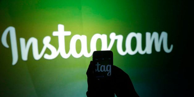 A journalist makes a video of the Instagram logo using the new video feature at Facebook headquarters in Menlo Park, Calif., Thursday, June 20, 2013. (AP Photo/Marcio Jose Sanchez)