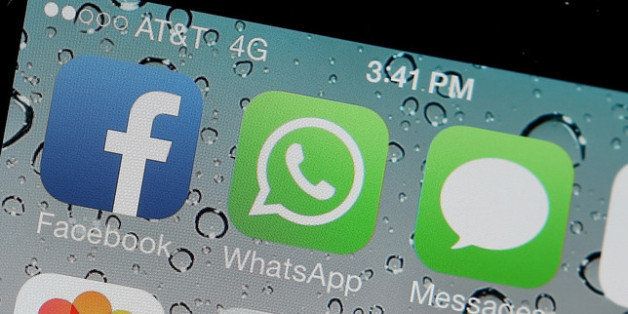 SAN FRANCISCO, CA - FEBRUARY 19: The Facebook and WhatsApp app icons are displayed on an iPhone on February 19, 2014 in San Francisco City. Facebook Inc. announced that it will purchase smartphone-messaging app company WhatsApp Inc. for $19 billion in cash and stock. (Photo illustration by Justin Sullivan/Getty Images)