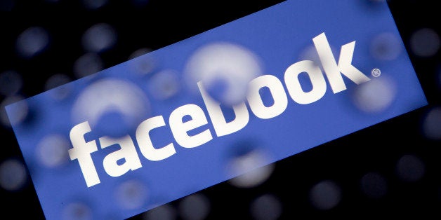 The Facebook Inc. logo is displayed an Apple Inc. iPad Air past water droplets in this arranged photograph in Washington, D.C