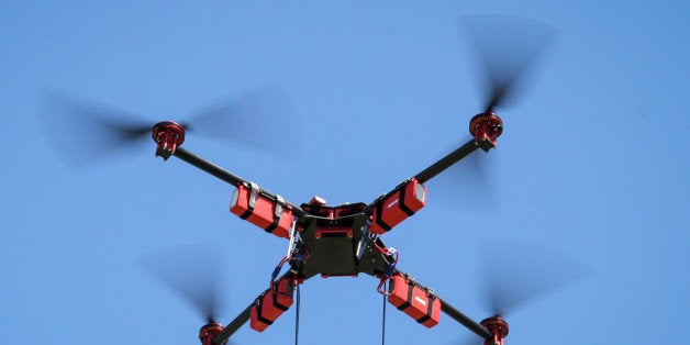A SteadiDrone QU4D aerial drone fitted with a GoPro video camera hovers in a field in Knysa, South Africa, on Wednesday, Feb.