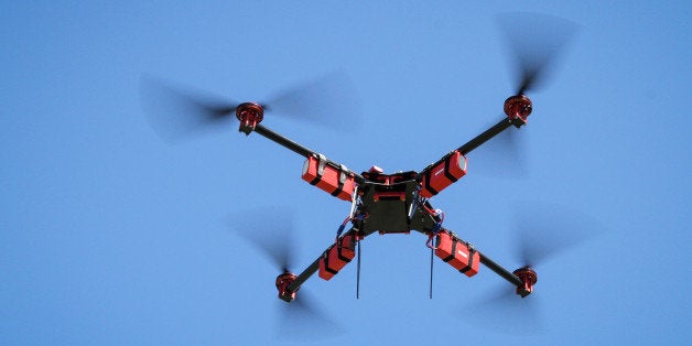 A SteadiDrone QU4D aerial drone fitted with a GoPro video camera hovers in a field in Knysa, South Africa, on Wednesday, Feb. 26, 2014. The number of civilian unmanned aircraft will reach 175,000 by 2035, most of them smaller models, a report by the Cambridge, Massachusetts-based Volpe National Transportation Systems Center found. Photographer: Dean Hutton/Bloomberg via Getty Images