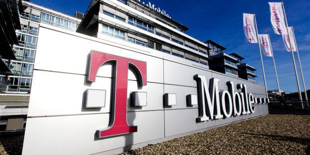 A logo for T-Mobile, operated by Deutsche Telekom AG, is seen on display outside the company's headquarters in Prague, Czech Republic, on Monday, Feb. 10, 2014. Deutsche Telekom AG agreed to acquire full ownership of its Czech unit, betting on a recovery in the eastern European telecommunications market that contribute to almost a quarter of the German carrier's revenue. Photographer: Martin Divisek/Bloomberg via Getty Images