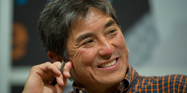 Guy Kawasaki, chairman and chief executive officer of Garage.com, listens as Mark Cuban, billionaire owner of the NBA Dallas