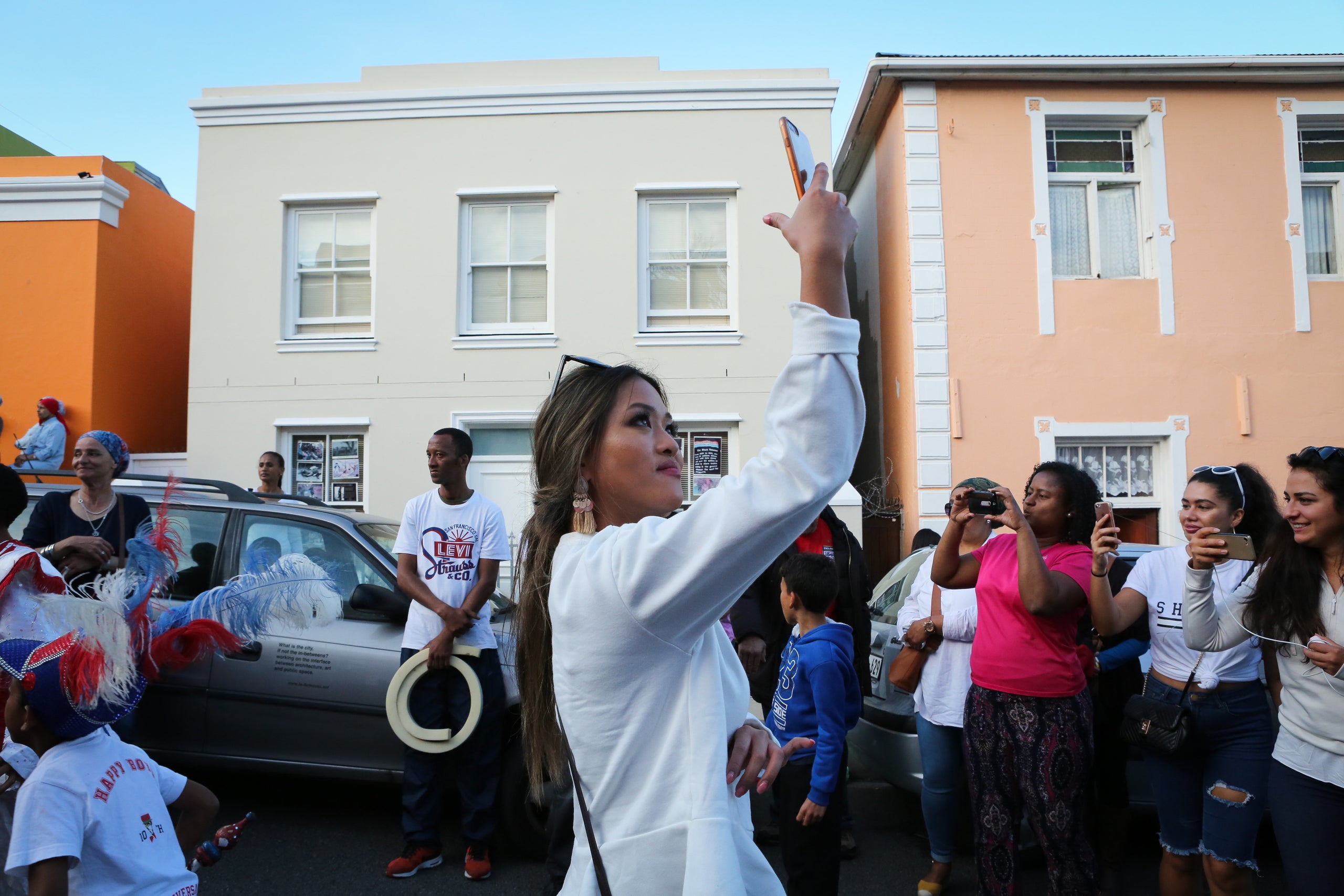 A womant takes photos in Bo-Kaap.