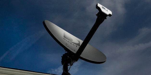 A DirecTV satellite dish stands on the roof of a home in Compton, California, U.S., on Monday, May 5, 2014. DirecTV beat anal