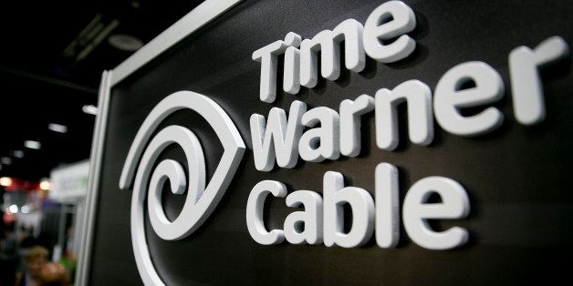 The Time Warner Cable Inc. logo is seen on the exhibit floor during the National Cable and Telecommunications Association (NCTA) Cable Show in Washington, D.C., U.S., on Tuesday, June 11, 2013. The Cable Show is expected to bring in more than 10,000 attendees with 286 companies on the exhibit floor. Photographer: Andrew Harrer/Bloomberg via Getty Images