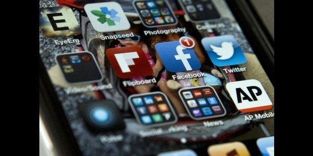 A view of an iPhone in Washington Tuesday, May 21, 2013, showing the Twitter and Facebook apps among others. A new poll finds