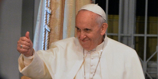 Pope Francis gives his thumb up during his visit to the St. Francis of Assisi Hospital in Rio de Janeiro's Tijuca neighbourhood, where he will inaugurate a psychiatric ward, on July 24, 2013. Earlier, the first Latin American and Jesuit pontiff visited Aparecida, in Sao Paulo State, to lead his first big mass since arriving in the country for a week-long visit of which highlight is the huge five-day Catholic gathering World Youth Day. AFP PHOTO / TASSO MARCELO (Photo credit should read TASSO MARCELO/AFP/Getty Images)