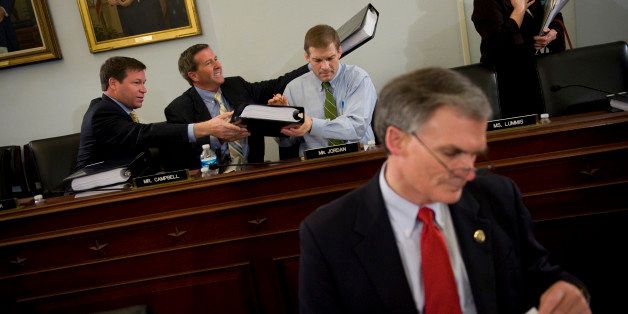 UNITED STATES - MARCH 15: From left, Rep. Connie Mack, R-Fla., John Campbell, R-Calif., and Jim Jordan, R-Ohio, pass out copies of the Reconciliation Act of 2010 before its markup in the House Budget Committee, March 15, 2010. Rep. Robert Latta, R-Ohio, reviews the bill. (Photo By Tom Williams/Roll Call/Getty Images)