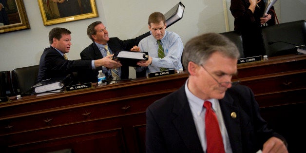 UNITED STATES - MARCH 15: From left, Rep. Connie Mack, R-Fla., John Campbell, R-Calif., and Jim Jordan, R-Ohio, pass out cop