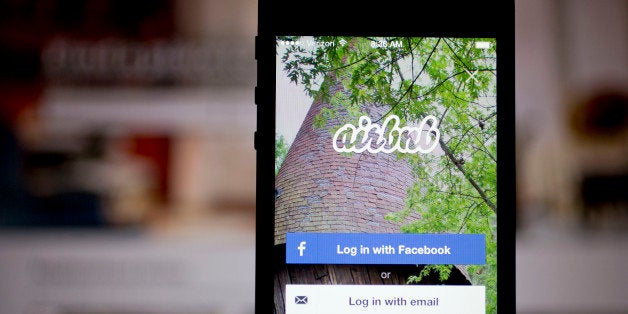 The Airbnb Inc. application and website are displayed on an Apple Inc. iPhone and iPad in this arranged photograph in Washington, D.C., U.S., on Friday, March 21, 2014. Airbnb Inc. is raising money from investors including TPG Capital in a financing round that would value the room-sharing service at more than $10 billion, said people with knowledge of the deal. Photographer: Andrew Harrer/Bloomberg via Getty Images