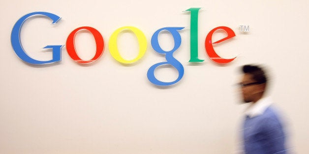 BERLIN, GERMANY - SEPTEMBER 26: A visitor passes the Google logo on September 26, 2012 at the official opening party of the G