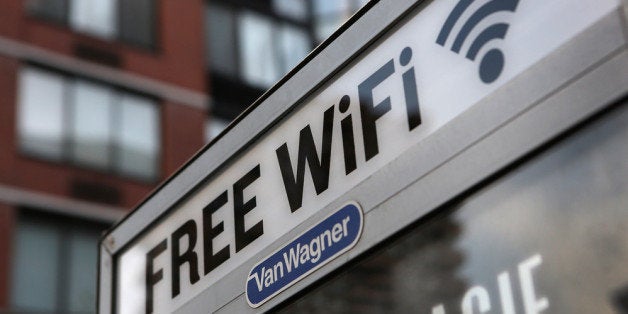 NEW YORK, NY - JULY 11: A free Wi-Fi hotspot beams broadband internet from atop a public phone booth on July 11, 2012 in Manhattan, New York City. New York City launched a pilot program Wednesday to provide free public Wi-Fi at public phone booths around the five boroughs. The first ten booths were lit up with Wi-Fi routers attached to the top of existing phone booths, with six booths in Manhattan, two in Brooklyn, and one in Queens. Additional locations, including ones in the Bronx and Staten Island, are to be added soon. (Photo by John Moore/Getty Images)