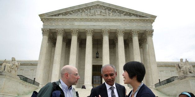 WASHINGTON, DC - APRIL 22: Aereo Vice President of Communications and Government Relations Virginia Lam (R) turns down a question from a member of the media (L) as Aereo CEO Chet Kanojia (2nd L) leaves the U.S. Supreme Court after oral arguments April 22, 2014 in Washington, DC. The Supreme Court heard arguments in a case against Aereo on the companys profiting from rebroadcasting network TVs programs obtained from public airwaves. (Photo by Alex Wong/Getty Images)