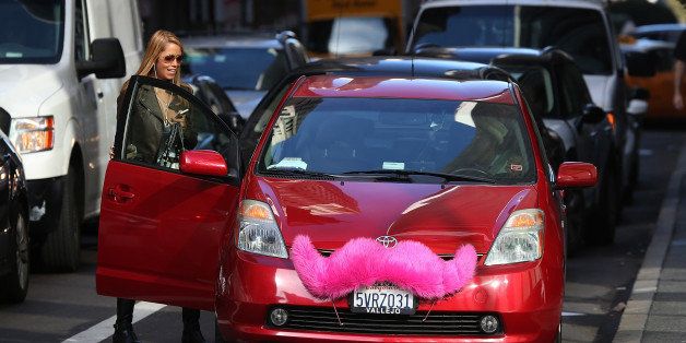 SAN FRANCISCO, CA - JANUARY 21: A Lyft customer gets into a car on January 21, 2014 in San Francisco, California. As ridesharing services like Lyft, Uber and Sidecar become more popular, the San Francisco Cab Driver Association is reporting that nearly one third of San Francisco's licensed taxi drivers have stopped driving taxis and have started to drive for the ridesharing services. (Photo by Justin Sullivan/Getty Images)