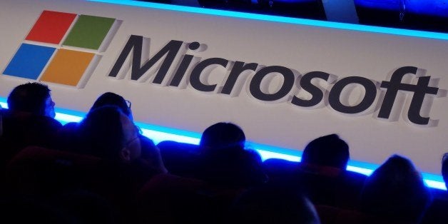 International buyers listen to a speeck in front of a Microsoft logo during the Computex tech show in Taipei on June 4, 2014. More than 1,500 exhibitors, including some of the world's leading technology brands, will set out their stalls at Computex in the capital, with 130,000 visitors expected for the five-day event. AFP PHOTO / SAM YEH (Photo credit should read SAM YEH/AFP/Getty Images)