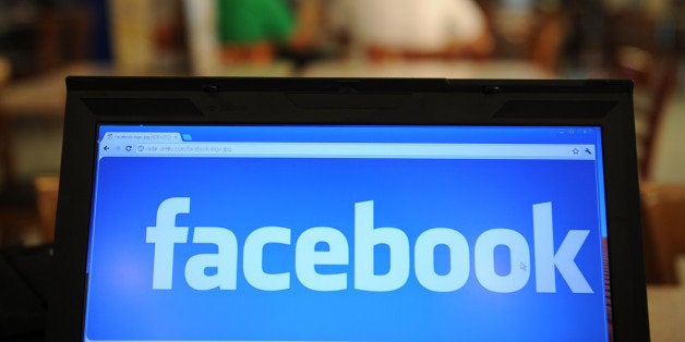 TO GO WITH Philippines-Internet-rights-law,lead-FOCUS by Cecil Morella (FILES) In a file picture taken on May 15, 2012, a logo of social networking facebook is displayed on a laptop screen inside a restaurant in Manila. A new cybercrime law in the Philippines that could see people sentenced to 12 years in jail for posting defamatory comments on Facebook or Twitter is generating outrage among netizens and rights groups. AFP PHOTO/TED ALJIBE/FILES (Photo credit should read TED ALJIBE/AFP/GettyImages)