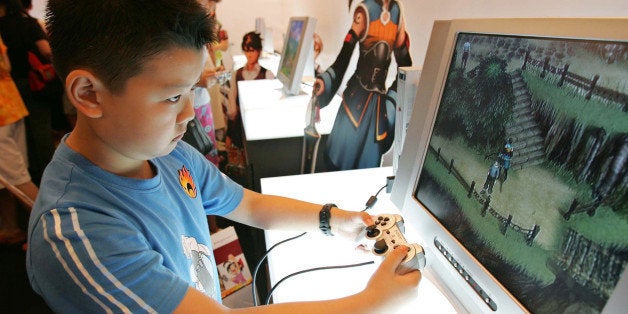 SHANGHAI, CHINA - JUNE 30: (CHINA OUT) A young boy plays Sony's Playstation 2 video game system at the 2005 Shanghai Animation FairJune 30, 2005 in Shanghai, China. China has a population of 370 million children and young people, making up a huge audience for cartoons and animation. Currently, 90 percent of the market is dominated by foreign producers from Japan and the U.S., with the largest share going to Japan. Most domestic cartoons are criticized for being old-fashioned and lackluster due to little originality in story and characters, dryness of content and persistent educational flavor. (Photo by China Photos/Getty Images)