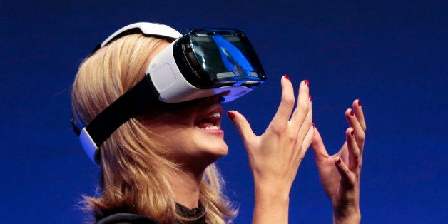 British television presenter Rachel Riley shows a virtual-reality headset called Gear VR during an unpacked event of Samsung