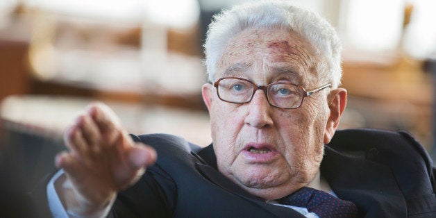 Former US Secretary of State Henry Kissinger gestures during a birthday reception for Kissinger's 90th birthday in Berlin, on