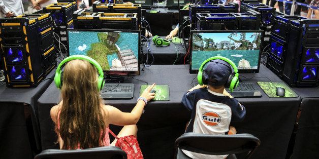ASCOT, ENGLAND - AUGUST 09: Young racegoers play in a Minecraft tournament during Ascot Dubai Duty Free Shergar Cup and Concert at Ascot Racecourse on August 9, 2014 in Ascot, England. (Photo by Miles Willis/Getty Images for Ascot Racecourse)